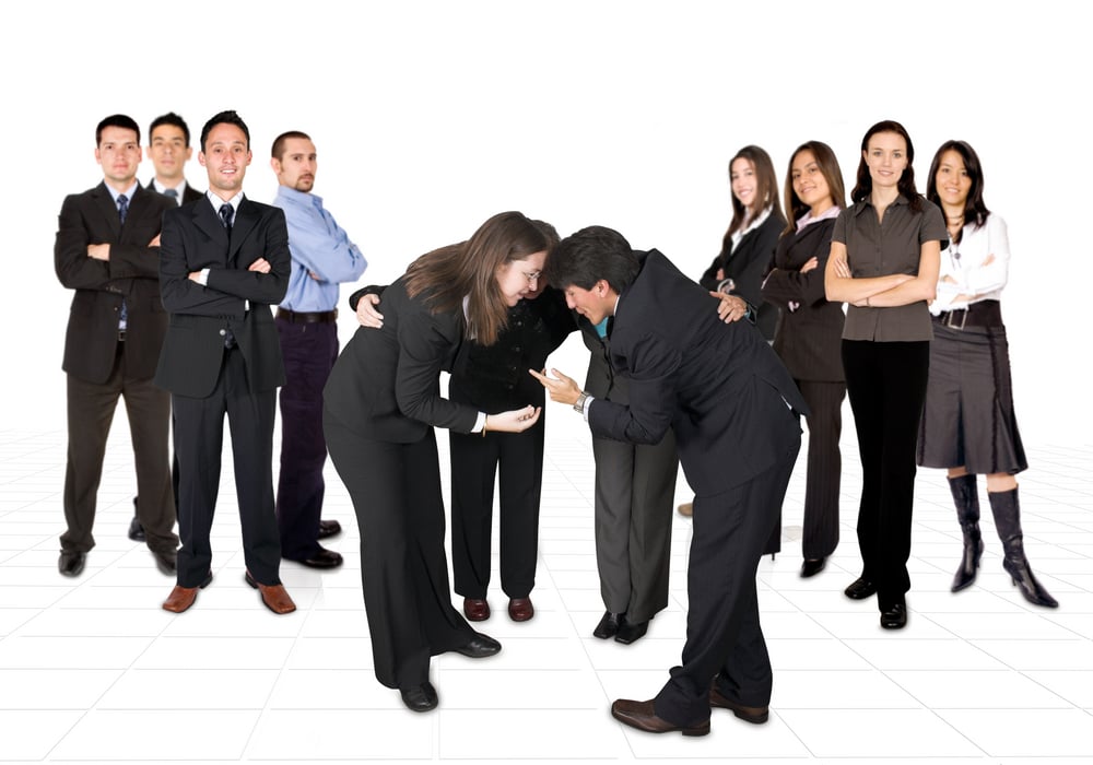 business men team on the left and women on the right, in the middle a mixed team with their heads together
